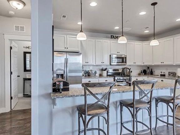 White Kitchen cabinets, grey granite counters. Stainless steel appliances.