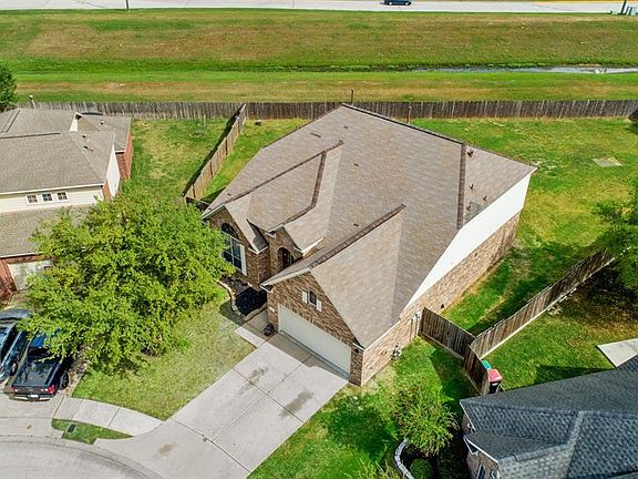 This home sits on an oversized cul-de-sac lot with a green space behind it