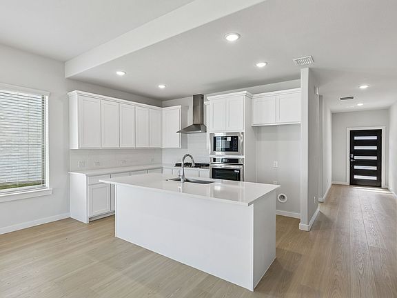 Kitchen in the Stanley II home plan by Trophy Signature Homes - REPRESENTATIVE PHOTO