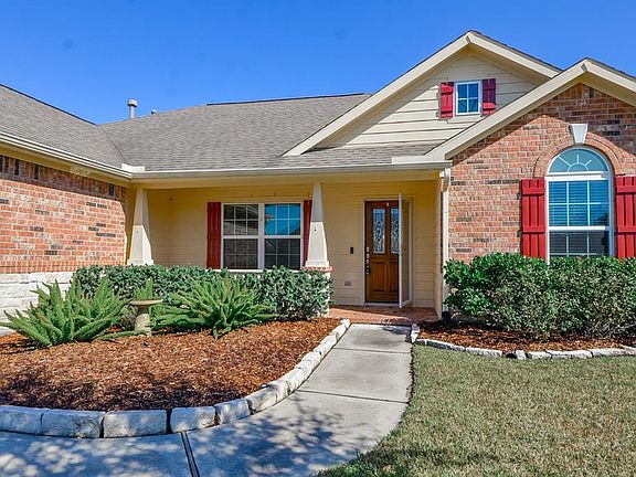 Red shutters add a tasteful pop of color and perfectly complement the brick. It's all in the details!