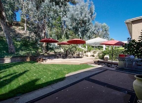 Check out the raised dining deck and forested slope.