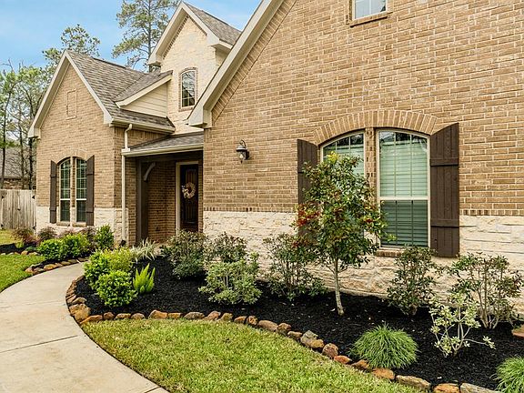 Highlights here include the dormer, covered porch, shutters and carriage lights.