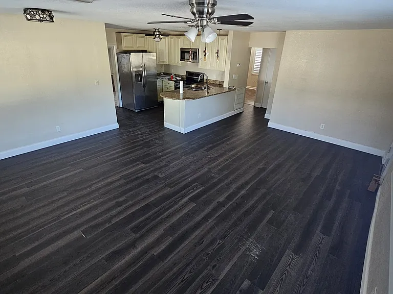 Front Living Room and dining/family area. Plantation shutters and brand new EVP floors.