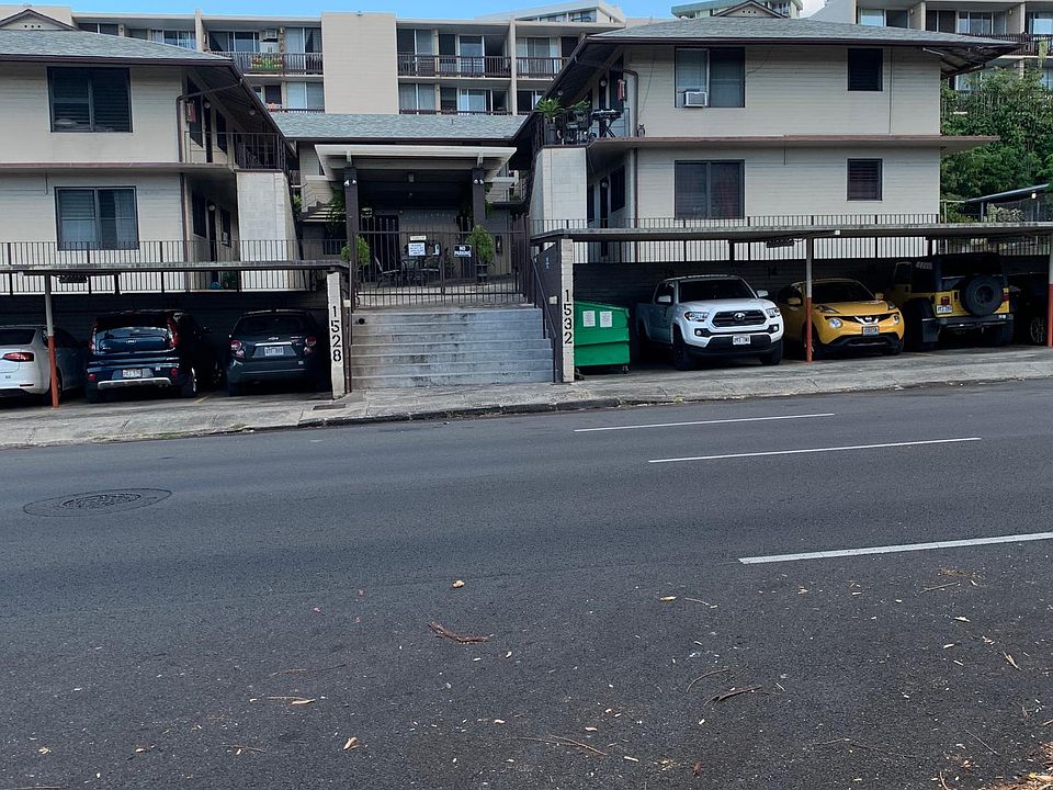 Front of property; main entry gate w/combination lock; parking in carport