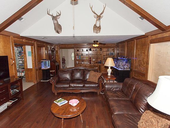 Rich hardwoods and vaulted ceilings with rustic beams