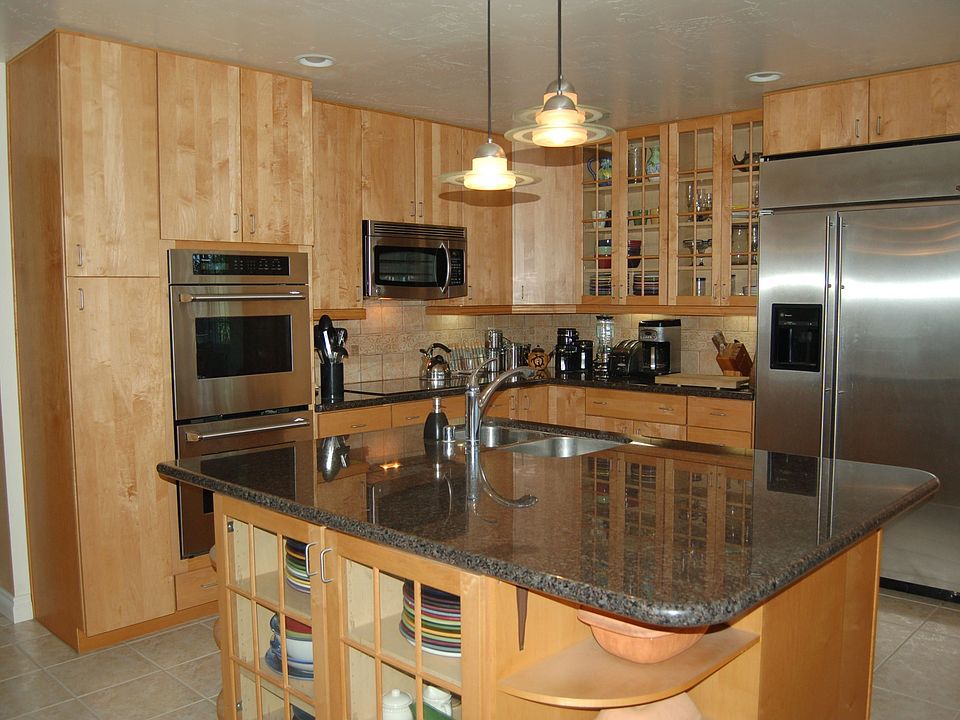 Kitchen with Granite Counter tops with unique tumbled marble backsplash.