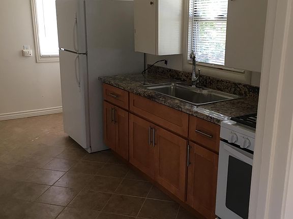 Kitchen with granite countertop and gas stove