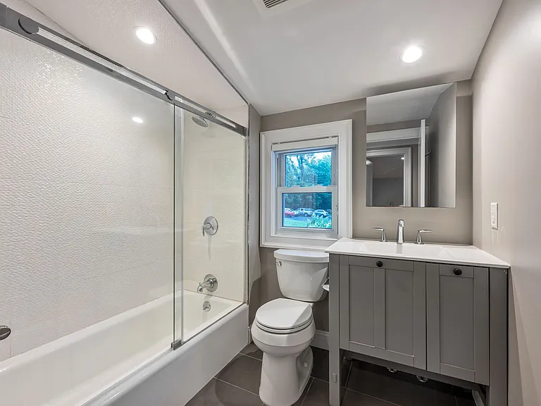 Full Hall Bath with Glass Enclosed Shower over Tub