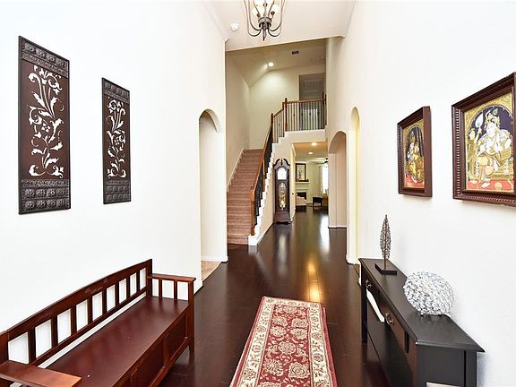 Grand Hall Entry has real wood floors that extend all the way through to the family room.