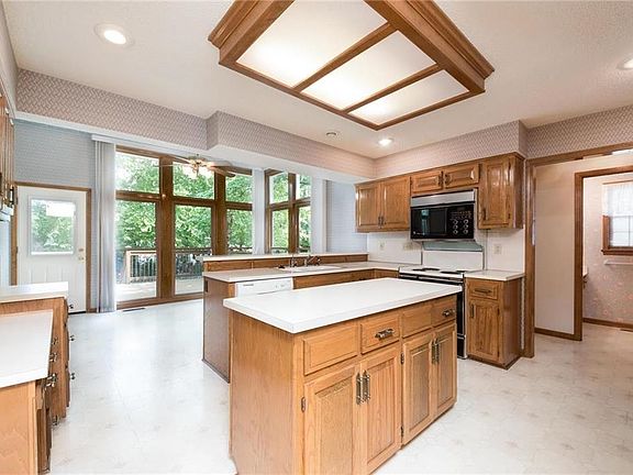 SPACIOUS KITCHEN HAS AMPLE CABINETS AND ISLAND