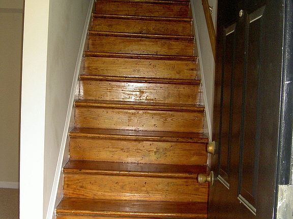 Stairs leading to both bedrooms and bath