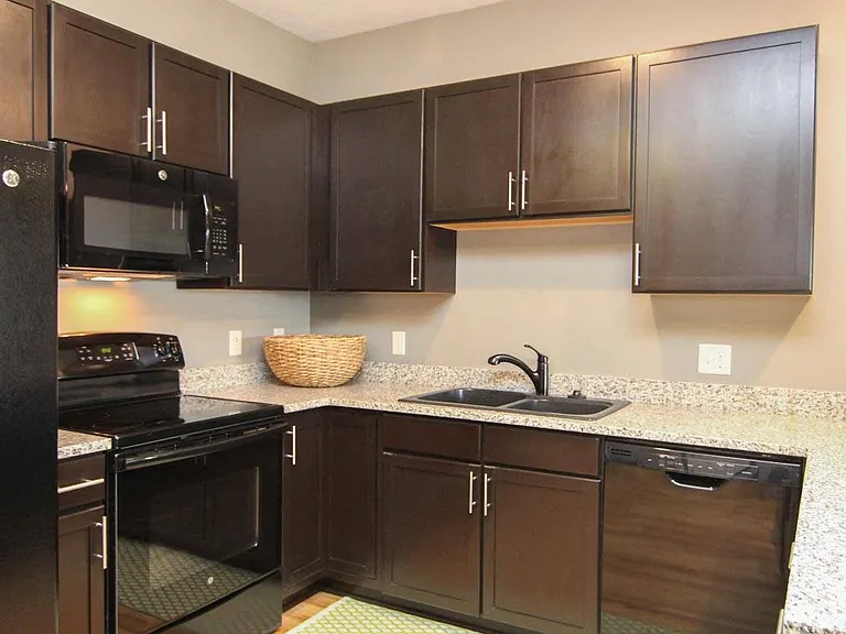 A modern kitchen with rich cabinetry and sleek finishes makes every meal feel like an experience.