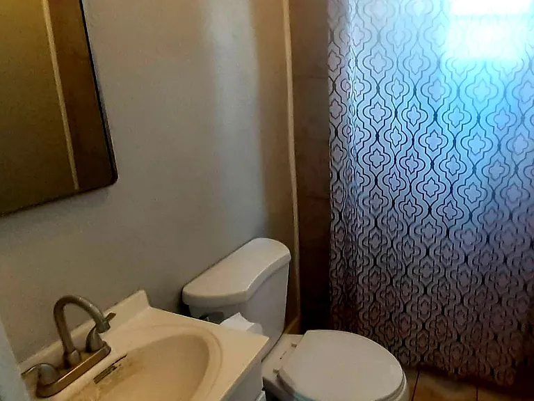 View of the rear bath with its large tile showerarea