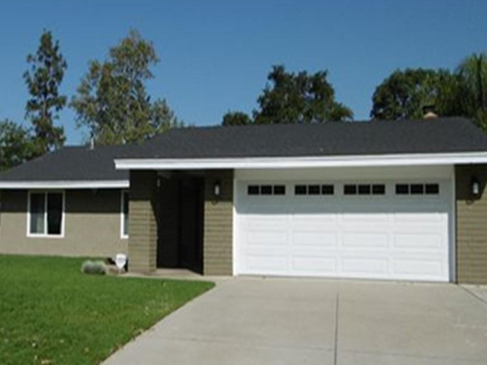 Wide driveway with extra parking. New garage door. Custom side gate and security doors. New double-pane windows throughout home.