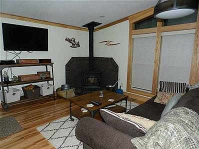 Living Room. Cool nights will be welcomed with this wood stove to cozy up to!