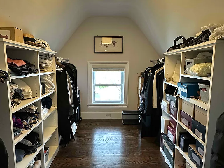 Generous walk-in closet with built-in shelving and excellent storage space in the master bedroom.