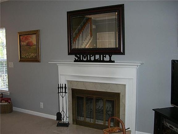 Marble surrounds this wood burning fireplace. Very cozy!