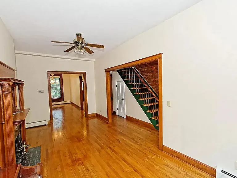 Living room and dining room (sweet brick wall to the right). Use your imagination and fill in the space. See the small door under the stairs, there is another door next to it that you cannot see that houses the half bath. Trust me.