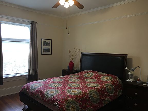 Spacious bedroom with overhead fan