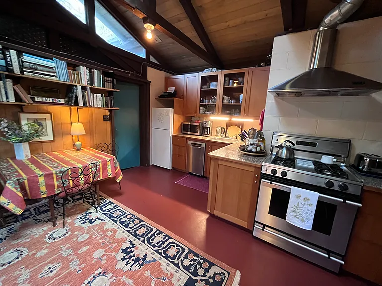 Kitchen with dishes, glassware, DW, Stove, refrigerator and sitting room