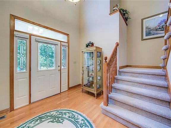 Grand entry-way, gleaming hardwoods, open flow to formal living room.