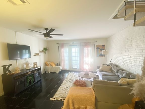 Living room: Sectional, TV, rug, coffee table, TV stand included.