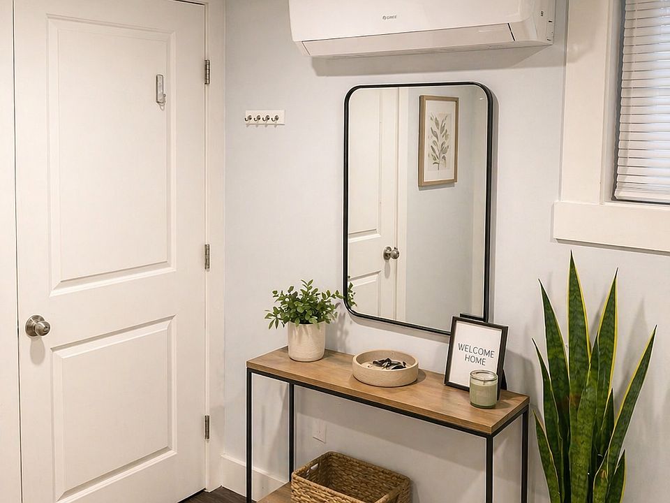 Stylish entryway showcasing clean design and high-efficiency split-unit system for optimal heating and cooling.