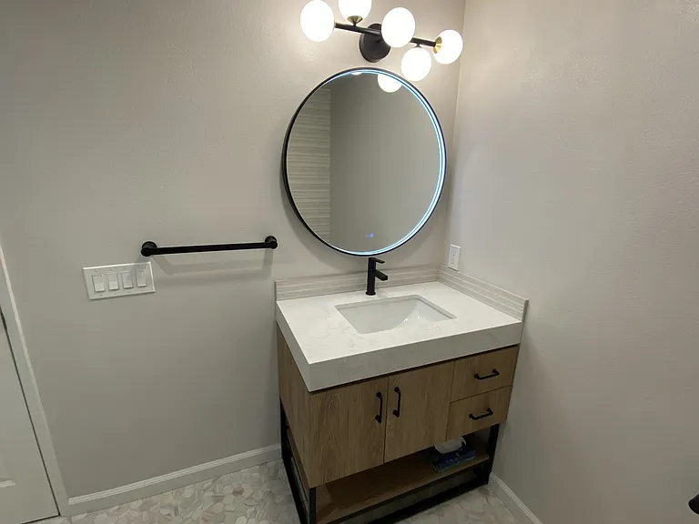 Spacious storage under vanity with plugs for hair dryer and charging phones