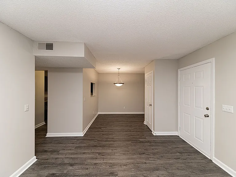 Dining area with hardwood-style flooring and overhead lighting