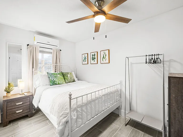 Bedroom with queen sized bed, private entrance, ceiling fan, black out curtains, mini-split AC.