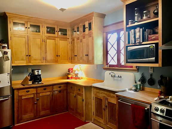 The farmhouse kitchen with stainless steel appliances.