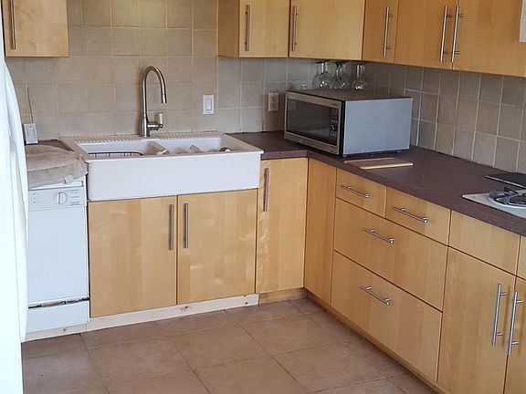 Large eat in kitchen with lots of cabinets.