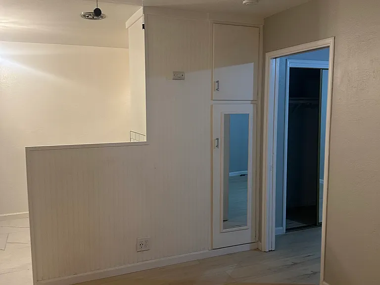 Living room with view towards kitchen and bedroom