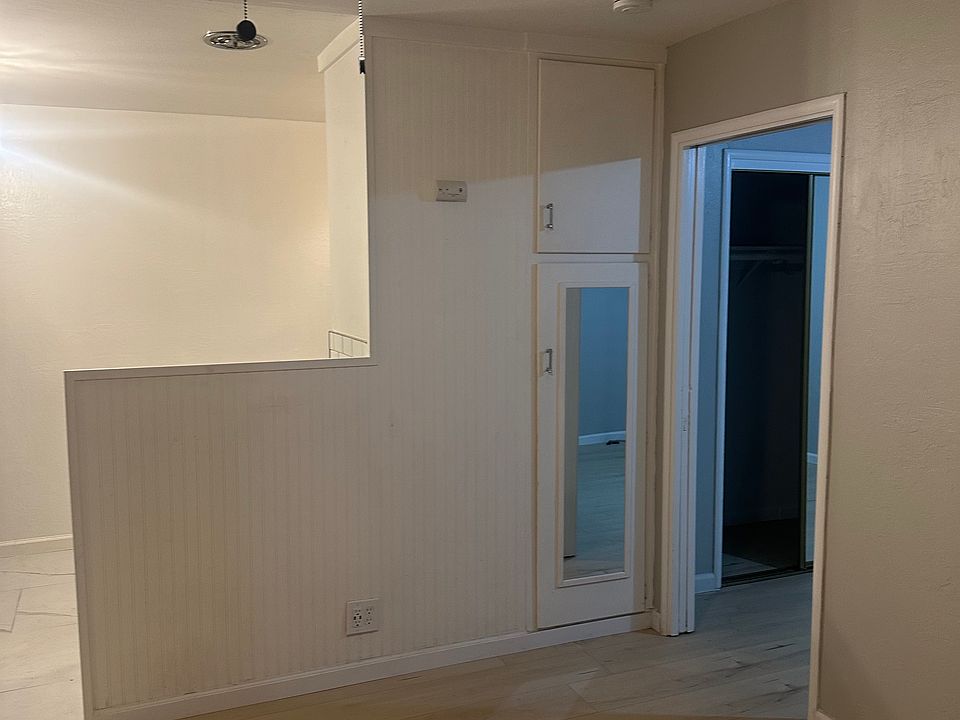 Living room with view towards kitchen and bedroom