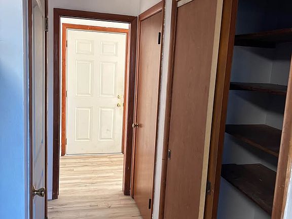 View from kitchen with pantry to the right, furnace room to the left and front door straight ahead.