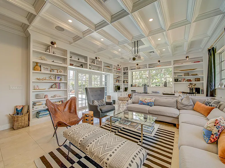 Family room with wrap around built -in bookcases.