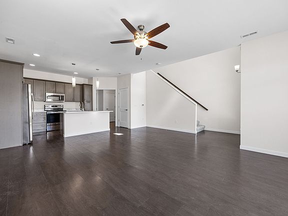 Open floor plan includes space for living and dining, as well as large kitchen island.