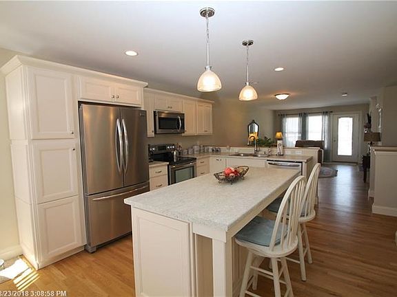 Nice open flow to living room with stainless steel appliances.