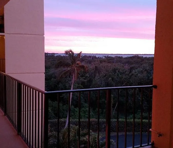 Just outside my front door . Beautiful sunset , you can see the Indian River Lagoon . You can see it a little more inside condo from balcony and kitchen window .