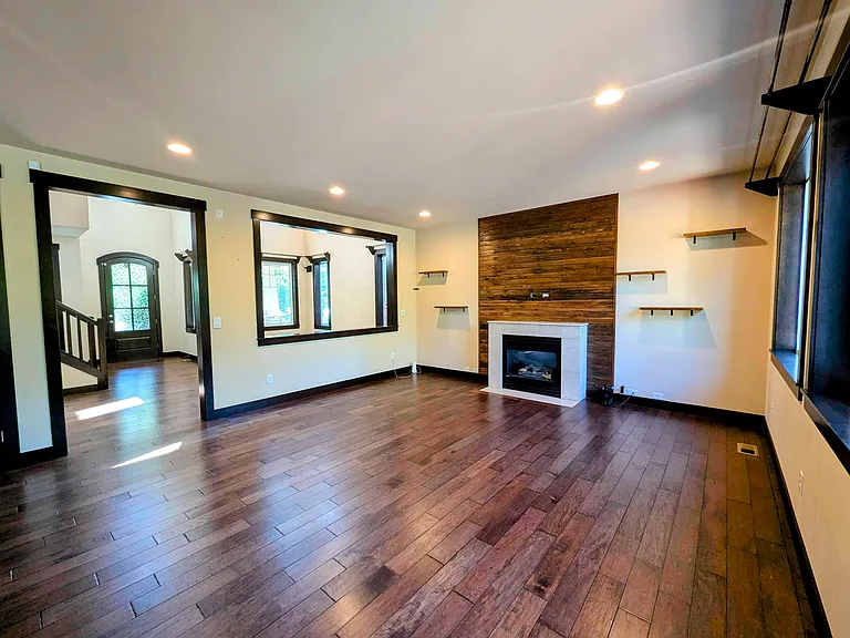 Great room with gas fire place and wood paneling.