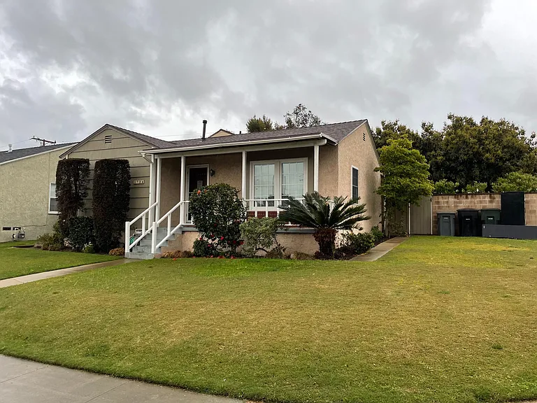 Corner lot with large grassy front yard.