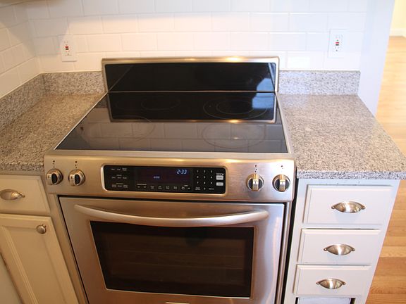 electric range/ granite counters/subway tiles in kitchen