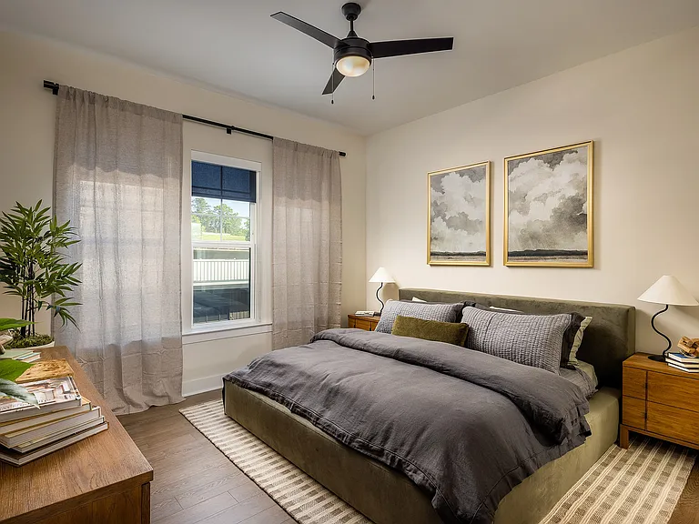Bedroom with oversized windows, high ceilings and natural light