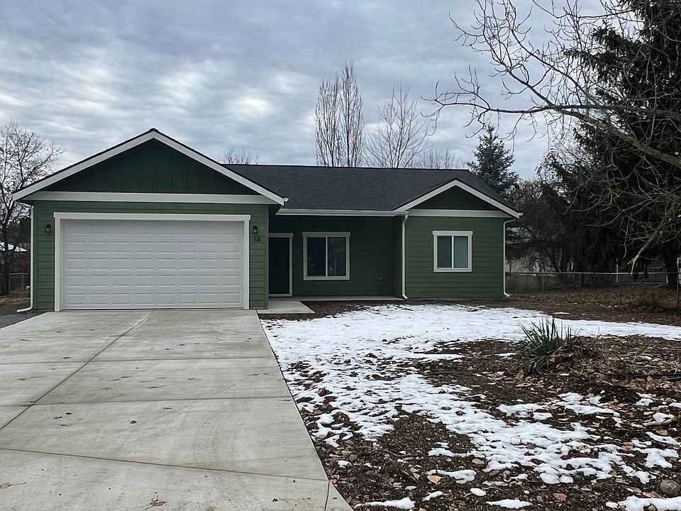 Front with large paved parking