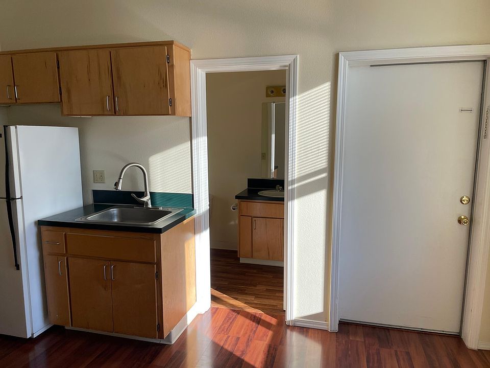 Kitchen sink area, bathroom doorway, front door.