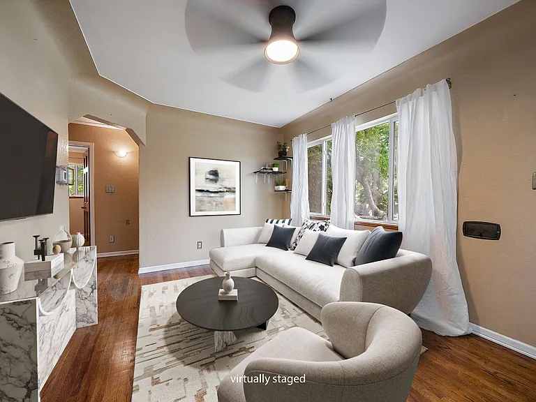 Living Room. Front door to the right just out of the picture and kitchen entrance to immediate left. Virtually staged photo