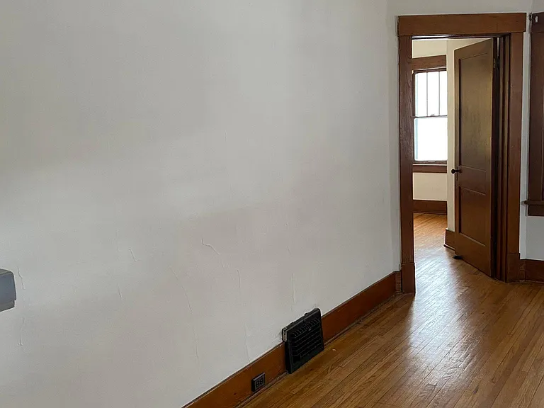 Living room with third bedroom in background