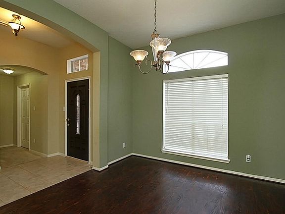 Front door and formal front dining room with hardwood and ceramic tile.