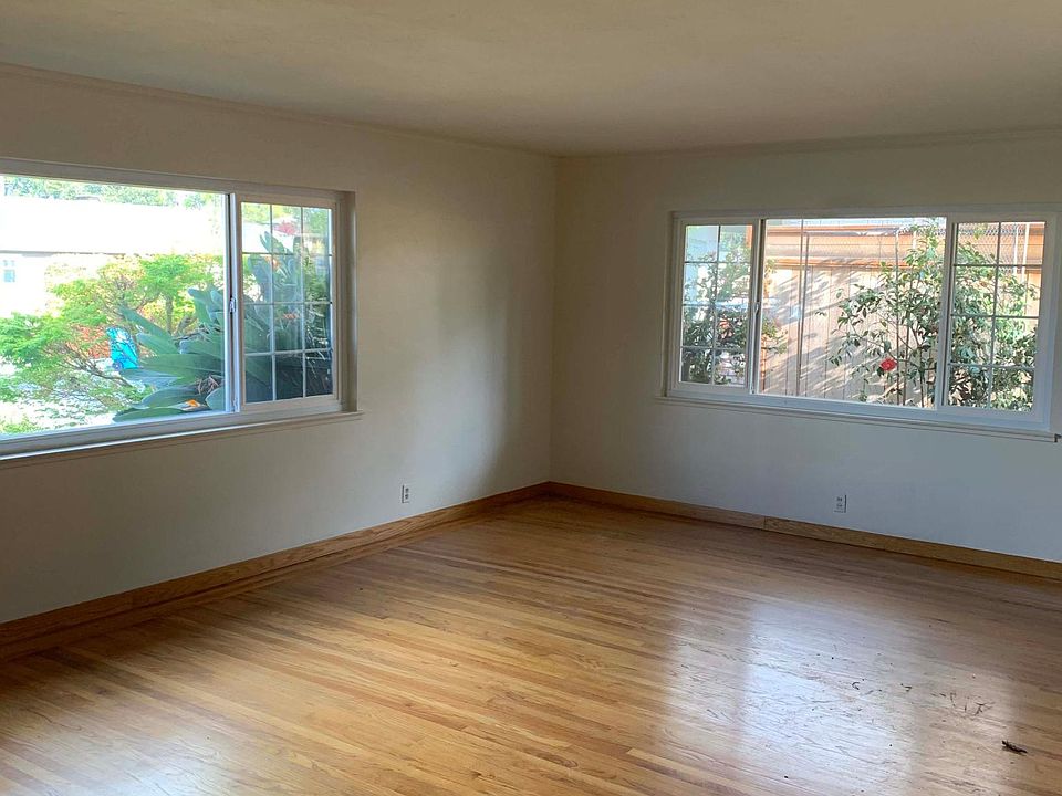 Livingroom with window facing the side entry to front door.