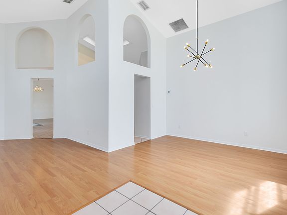 Dining area connecting to Kitchen with ample lighting and high ceilings